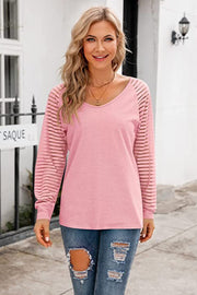 Striped sleeve raglan V-neck top in Carnation Pink with sheer striped sleeves.