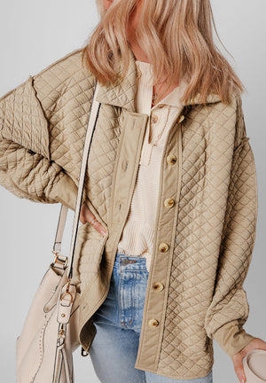 Beige diamond quilted oversized button-up jacket with textured sleeves and collar.