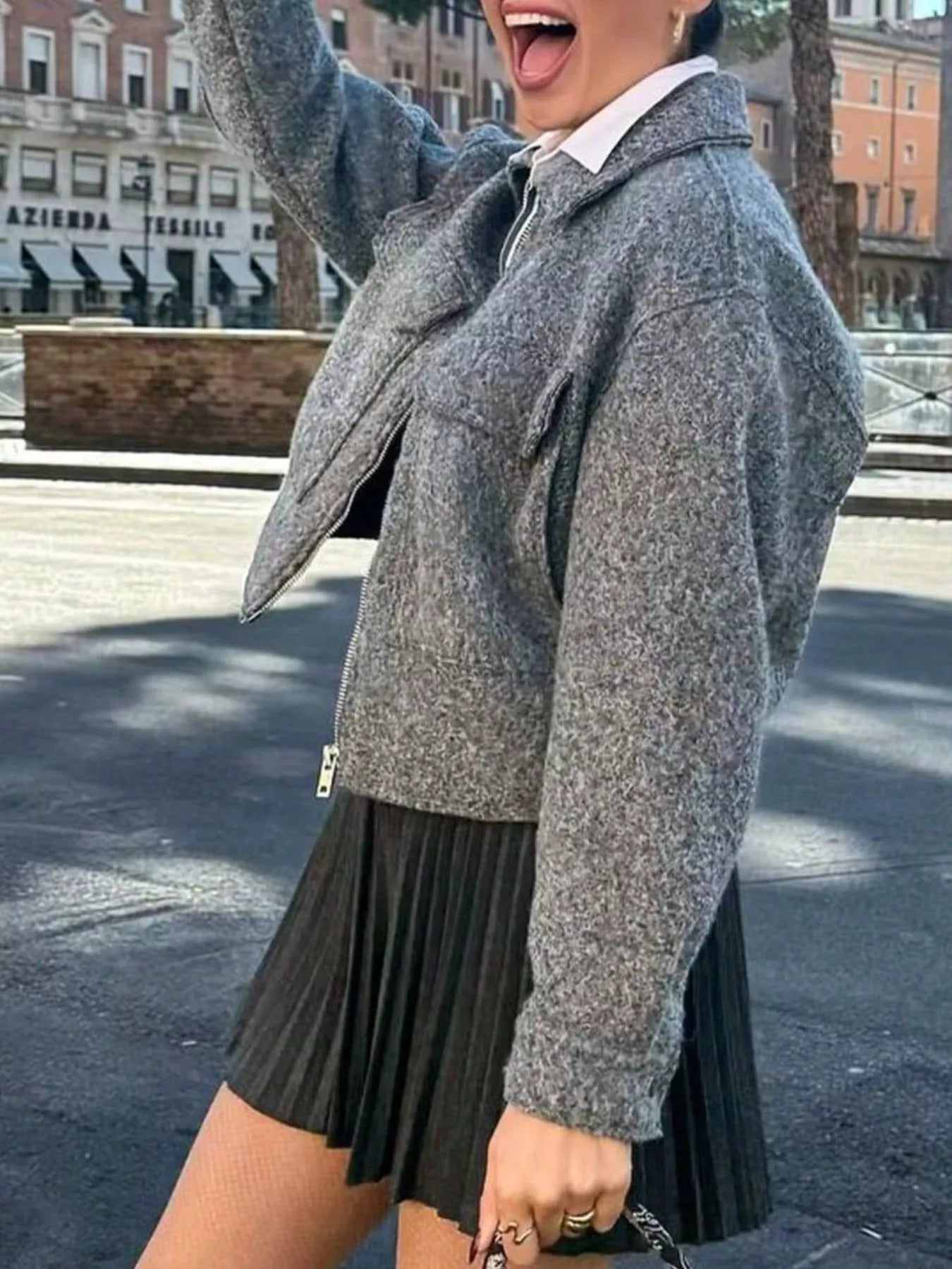 Gray cropped zip-up jacket with pockets and a collared neckline.