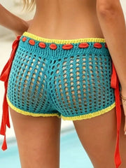 Teal crochet shorts with yellow trim, red tie sides, and openwork detail.