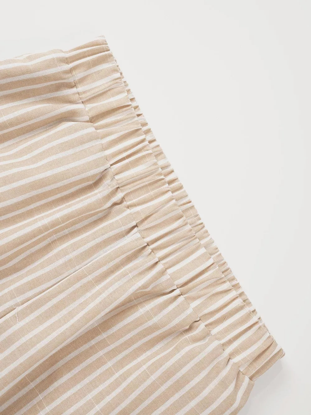 Chic high-waisted striped wide-leg pants with elastic waistband in beige and white linen blend.