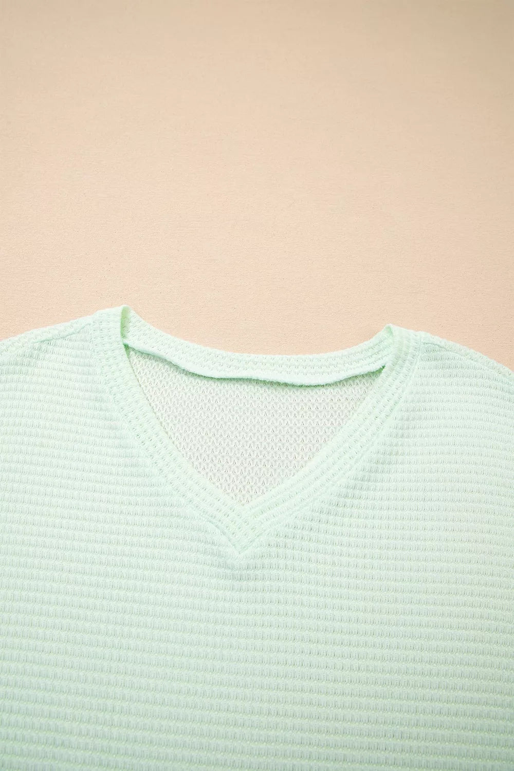 Light green waffle knit V-neck maternity t-shirt with relaxed fit.