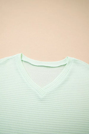 Light green waffle knit V-neck maternity t-shirt with relaxed fit.