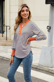 Striped long sleeve blouse with orange neckline and cuffs, v-neck henley style