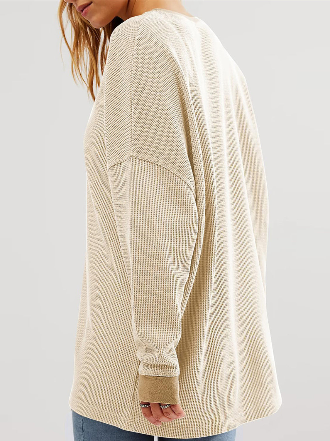 Tan waffle knit raglan sleeve sweatshirt with crew neck and cuffed sleeves.