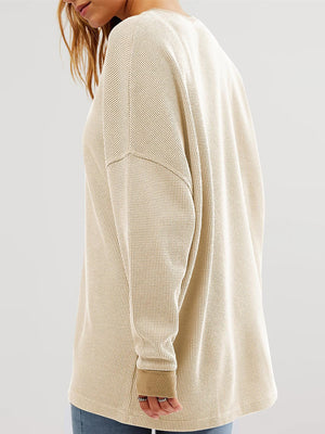 Tan waffle knit raglan sleeve sweatshirt with crew neck and cuffed sleeves.