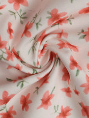Floral mini dress with V-neck and puff sleeves in a light pink fabric with coral flowers and green leaves.