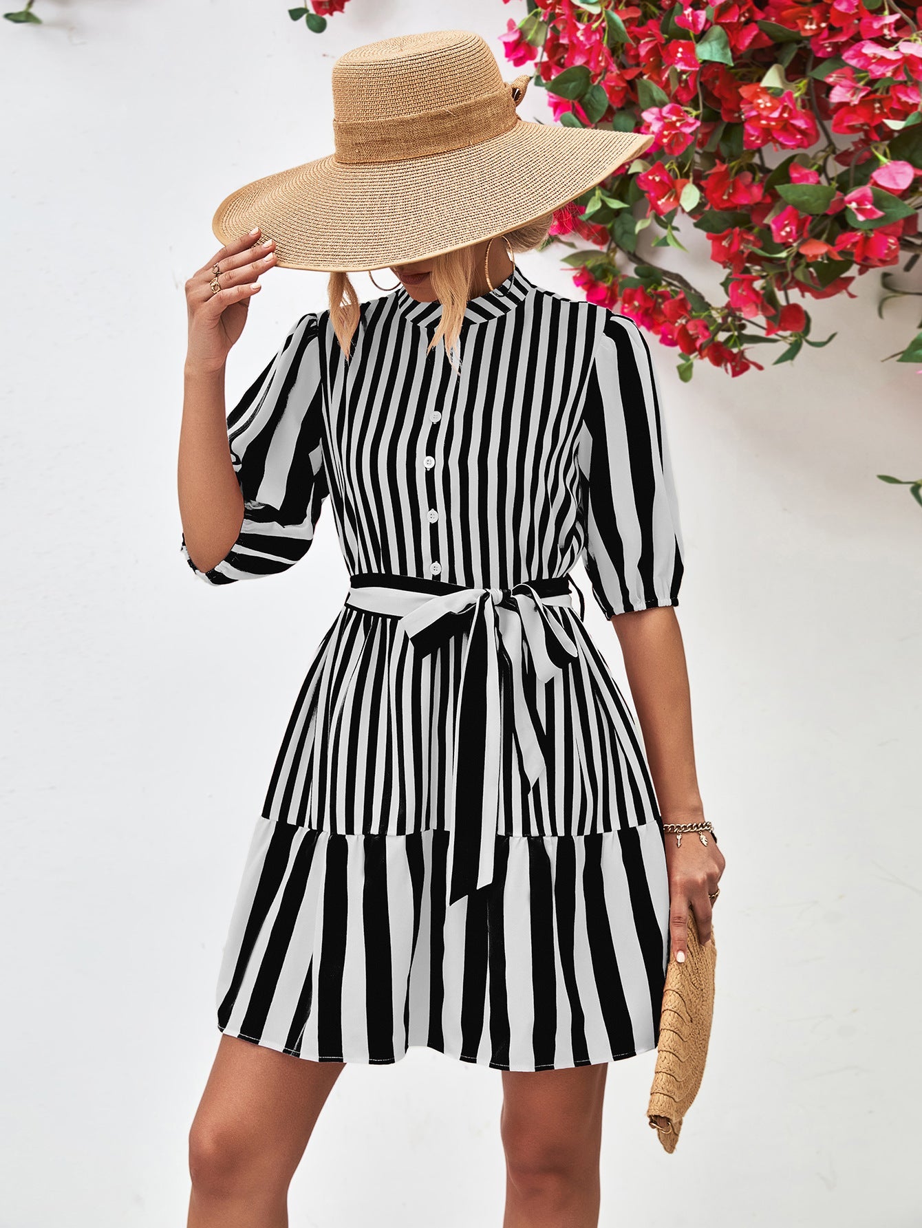 Black and white striped shirred waist dress with tie belt and tiered skirt.