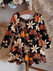 Baby dress with long sleeves and autumn leaves print on black polyester fabric.