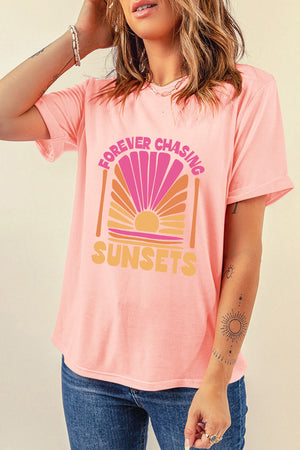 Watermelon pink graphic tee with "Forever Chasing Sunsets" text and a retro sunset design.