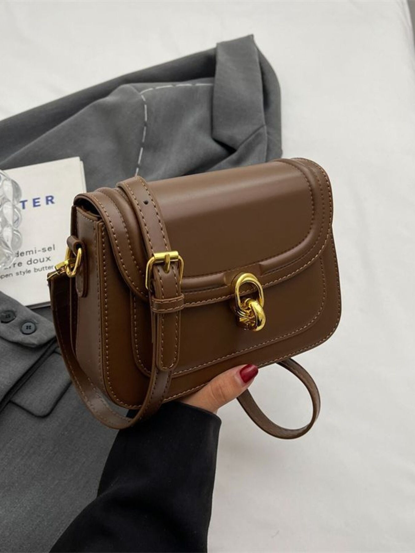 Premium Pu leather flap crossbody bag in coffee color with gold hardware and adjustable strap.