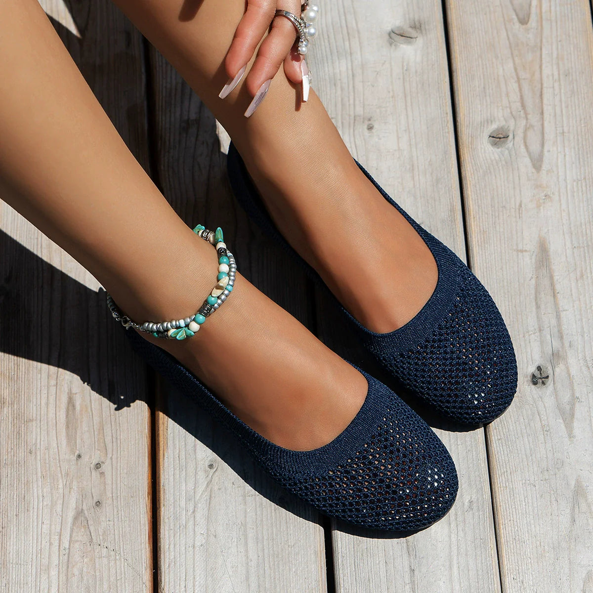 Indigo knit ballet flats with a breathable mesh texture and round toe.