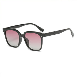 Chic square gradient tint sunglasses with black frames and pink to clear lenses.