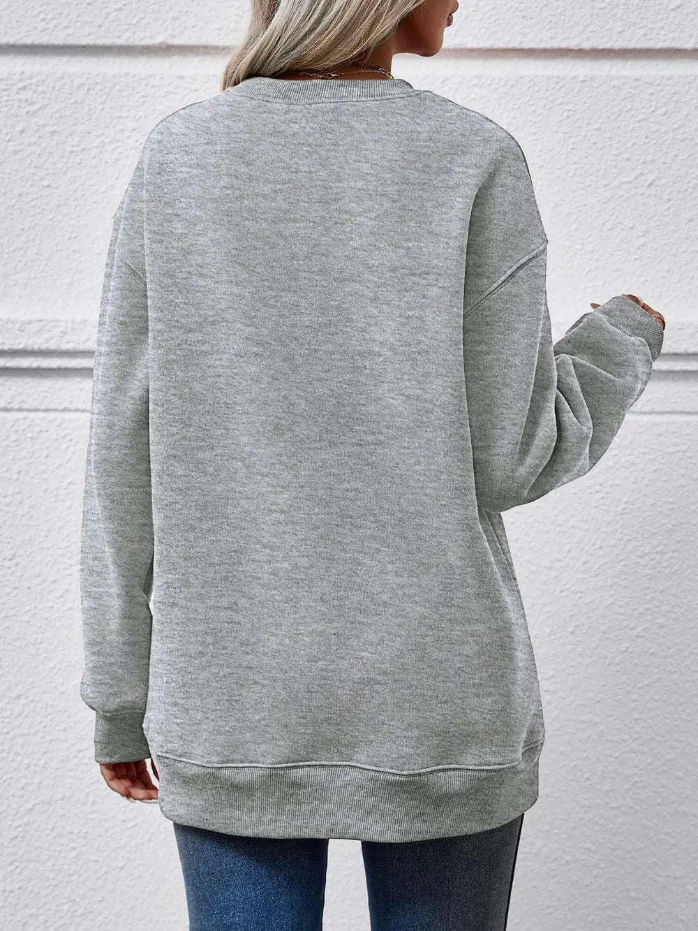 Crewneck sweatshirt in charcoal with a graphic print on the back.