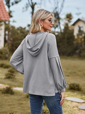 Gray ribbed hoodie with balloon sleeves and a hood, shown from the back.