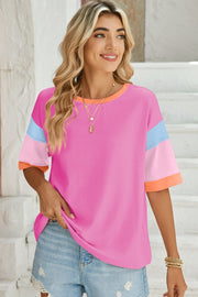 Panel sleeve crewneck tee in bright pink with colorblock sleeves and neckline.