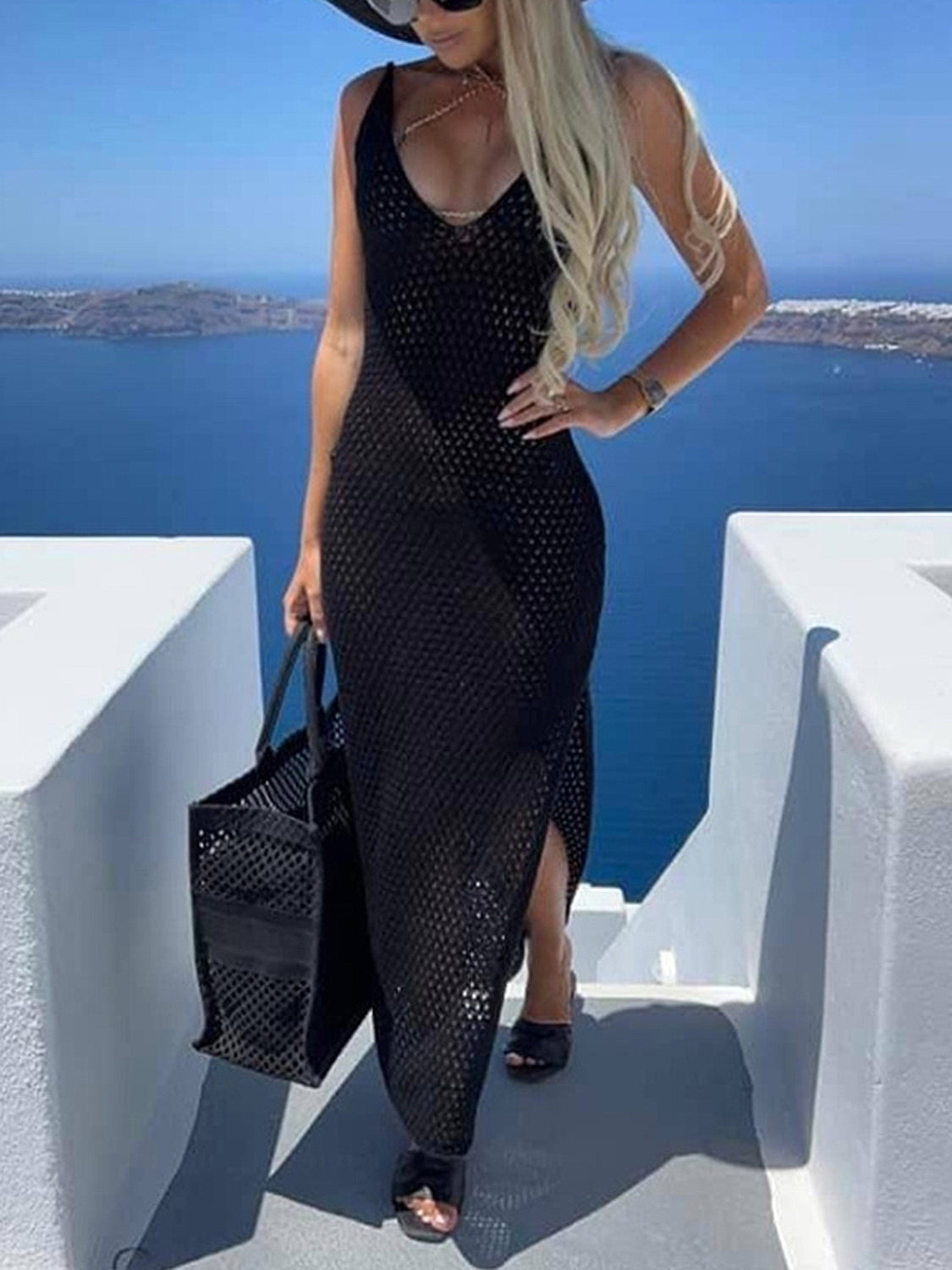 Black open-knit maxi dress with V-neck, thigh slit, and sleeveless cut.