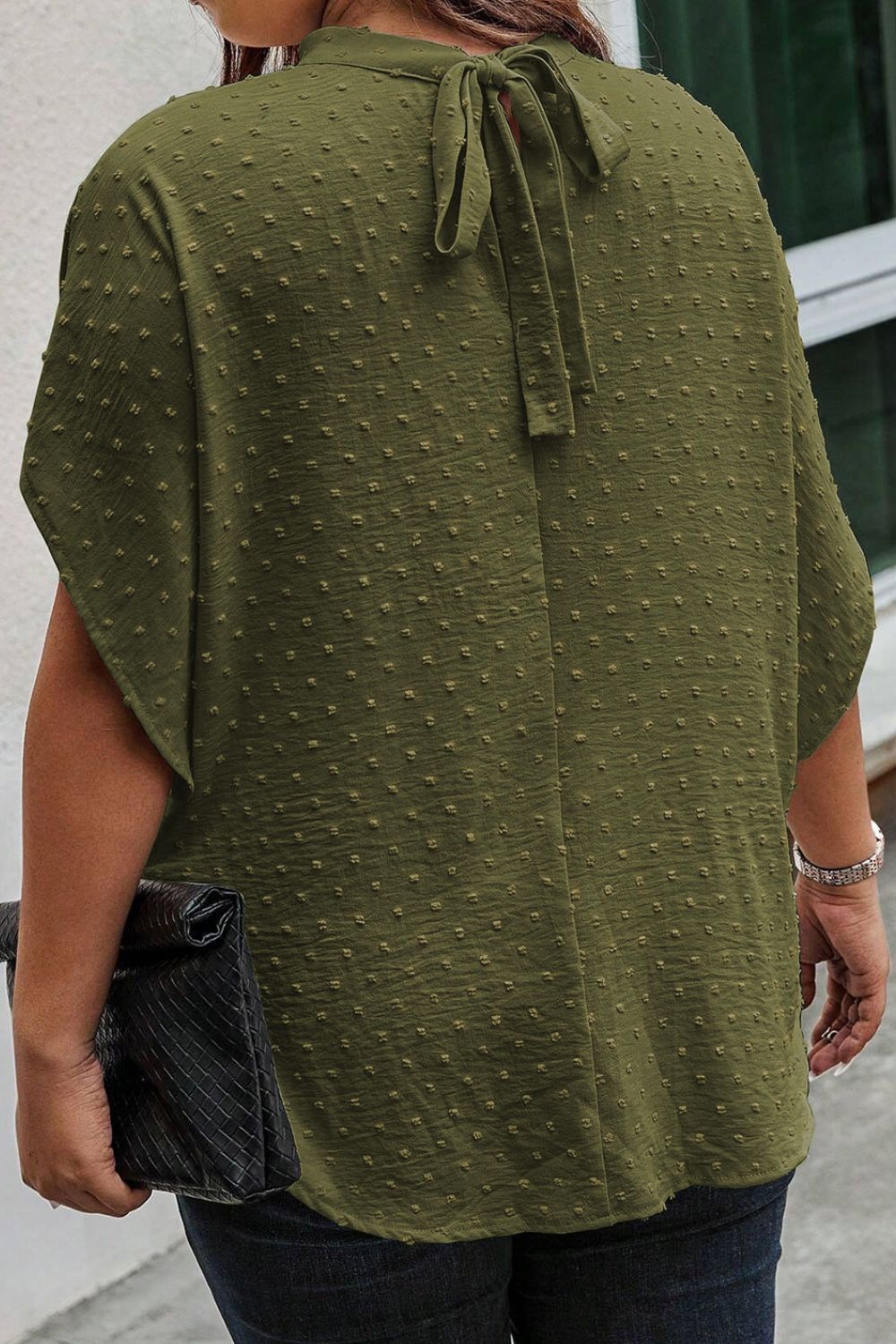 Matcha green Swiss dot blouse with short sleeves and a keyhole back tie detail.