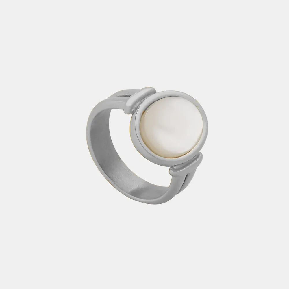 Silver signet ring with a round mother-of-pearl inlay and modern band design.