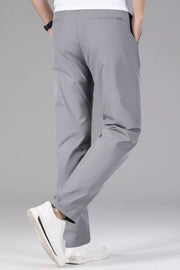 Men's gray slim-fit stretch dress pants with a clean, modern cut.