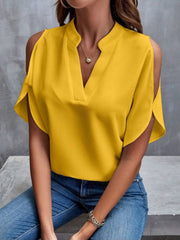 Yellow open-shoulder blouse with mandarin collar and V-neck.