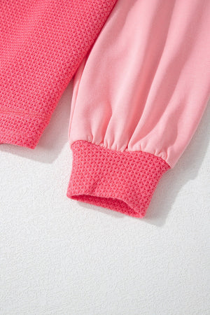 Blush pink shacket with waffle knit panels and elastic cuffs.