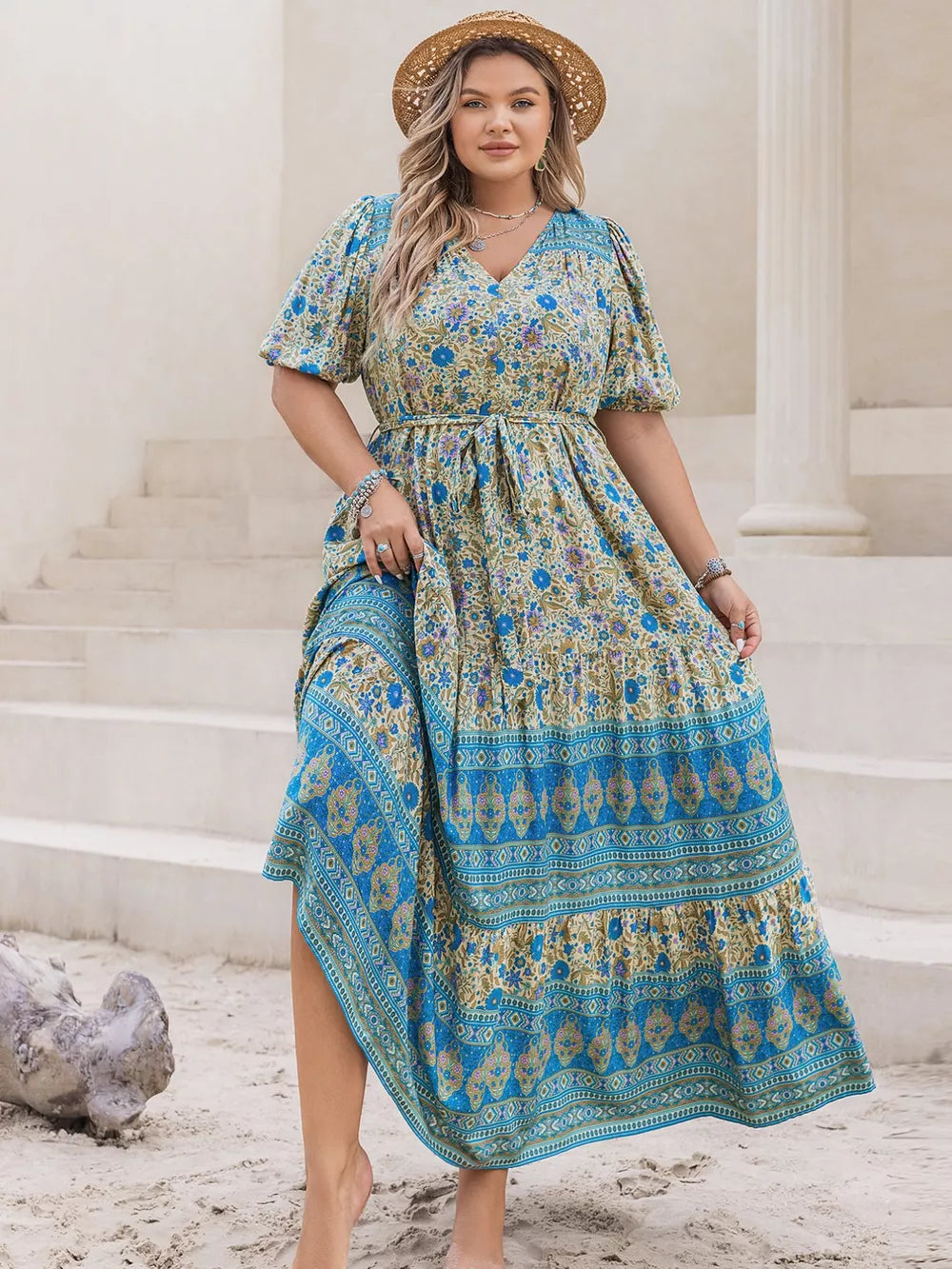 Bohemian floral maxi dress with tie waist, V-neck, short sleeves, and tiered skirt in blue and tan.