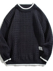 Men's black textured knit sweater with white striped collar and cuffs.