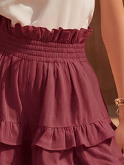 Ruffled high-waisted shorts in red with smocked waistband and tiered ruffles.
