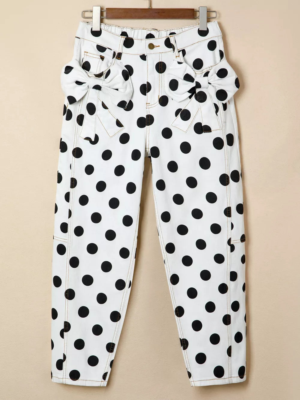 White polka dot denim jeans with bow pocket details
