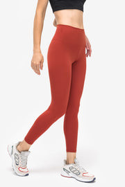 StealthFit pocketed leggings in brick red, high-waisted, full-length activewear pants.