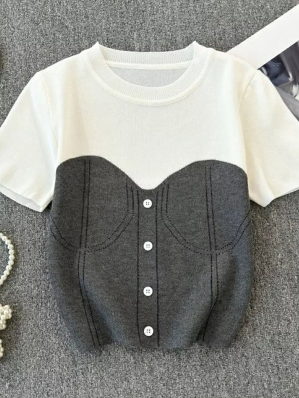 Color block knit t-shirt in white and gray with ribbed detail and button accents
