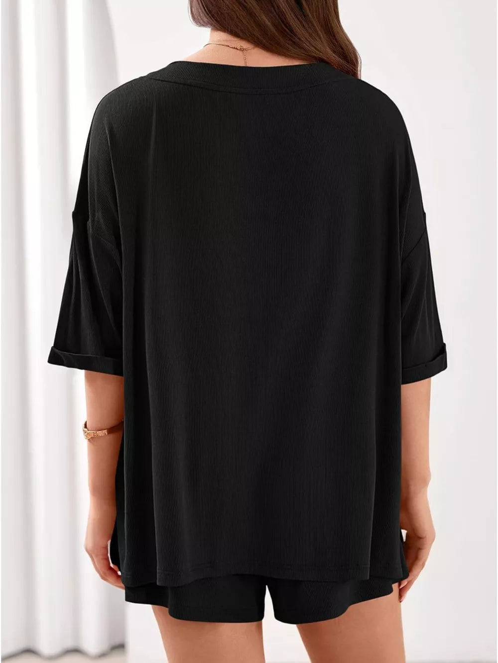 Black ribbed V-neck lounge set with cuffed short sleeves and matching shorts.