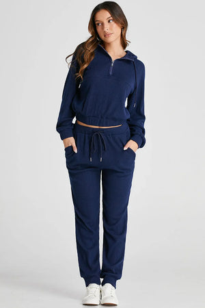 Navy ribbed crop hoodie with quarter zip and matching jogger pants with drawstring waist.
