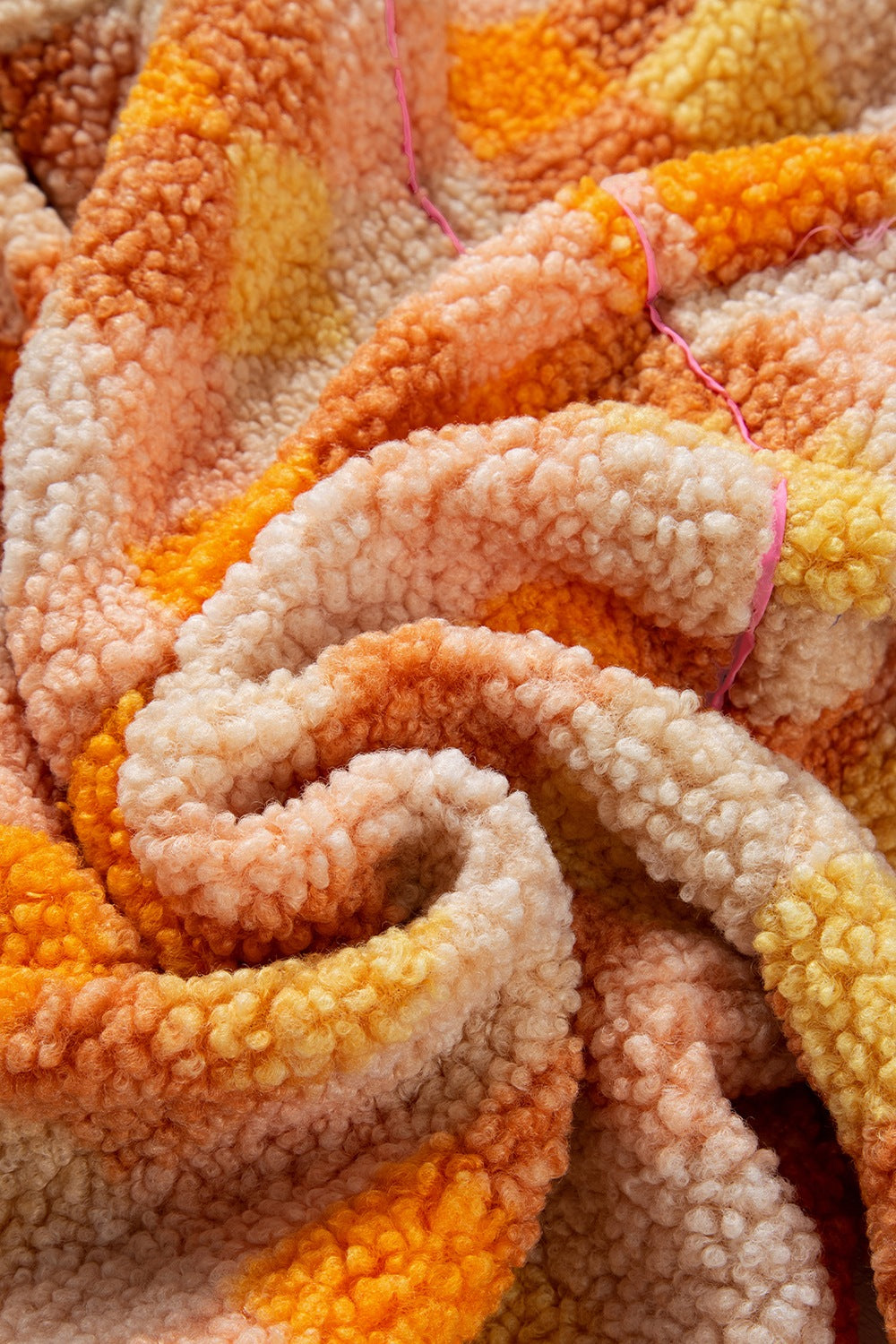 Checkerboard sherpa jacket in tangerine with fuzzy texture and pink trim detail
