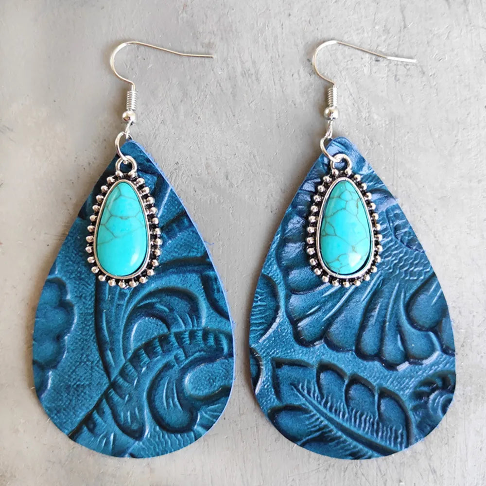 Aqua tooled leather teardrop earrings with turquoise stone accents and silver hooks.