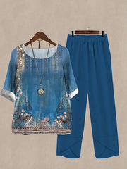 Floral print half sleeve top and blue pants set with round neck and white cuffs.