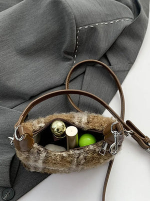 Shearling check mini shoulder bag with brown trim and strap, open to show makeup.