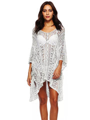 White crochet v-neck beach cover-up with intricate cutout pattern and asymmetrical hem.