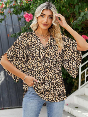 Leopard print blouse with flutter sleeves and V-neck, made of 100% polyester.