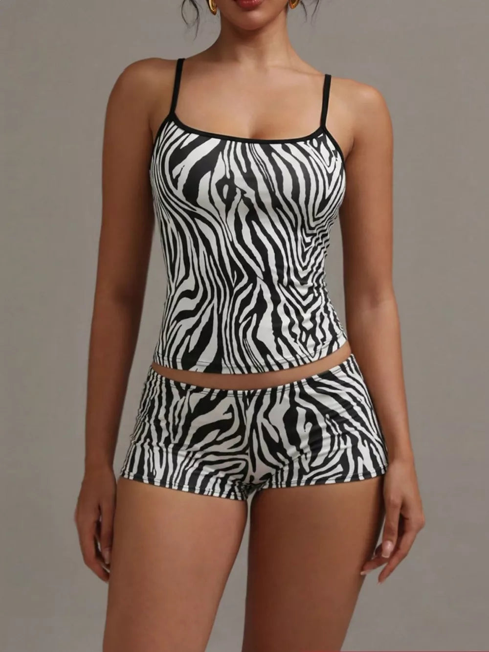 Women's zebra print cami and shorts pajama set with black trim.