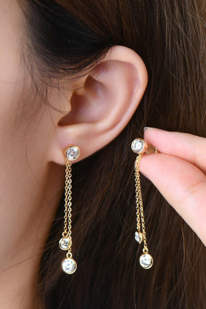 Gold cascade drop earrings with cubic zirconia stones and delicate chains.