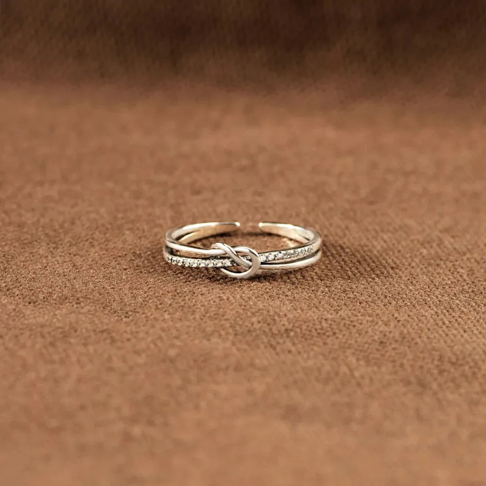 Silver pavé knot ring with double band detail