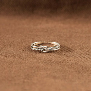 Silver pavé knot ring with double band detail