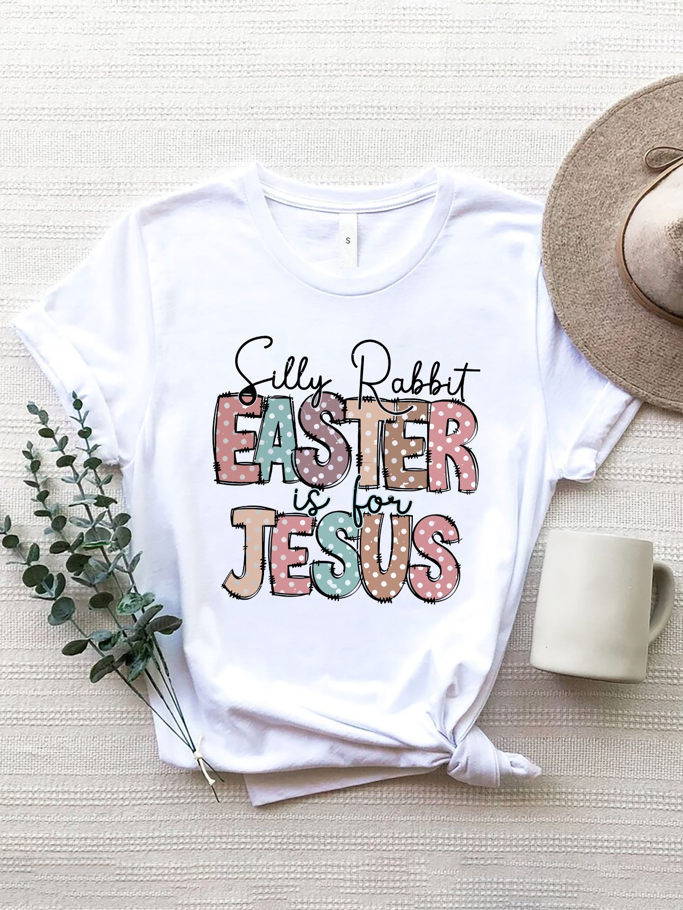 White Easter graphic tee with pastel polka dot text "Silly Rabbit EASTER is for JESUS
