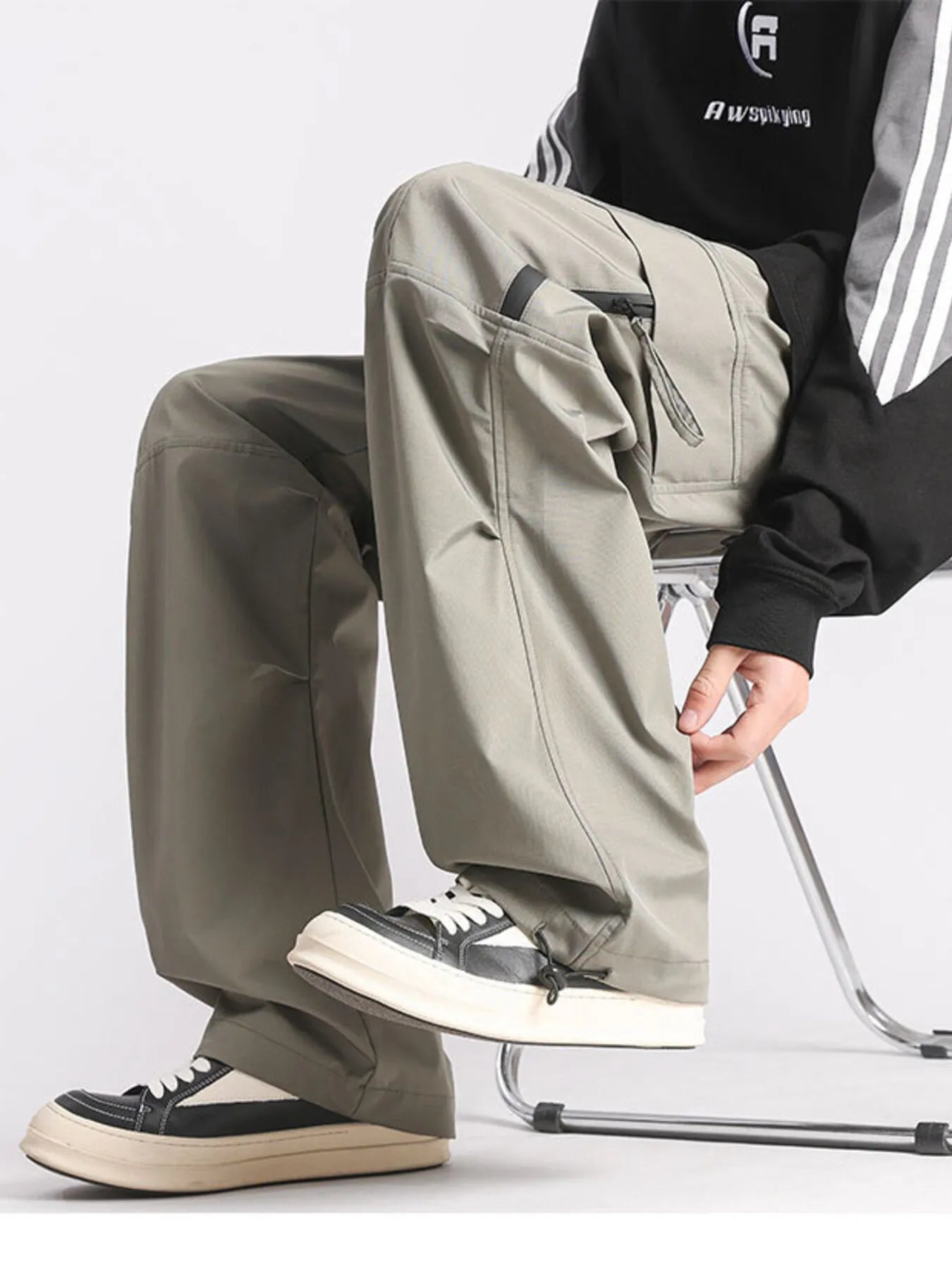 Plus-size loose fit cargo pants in green with multiple pockets and drawstring ankles.