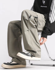 Plus-size loose fit cargo pants in green with multiple pockets and drawstring ankles.