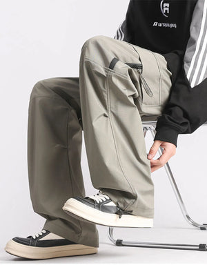Plus-size loose fit cargo pants in green with multiple pockets and drawstring ankles.