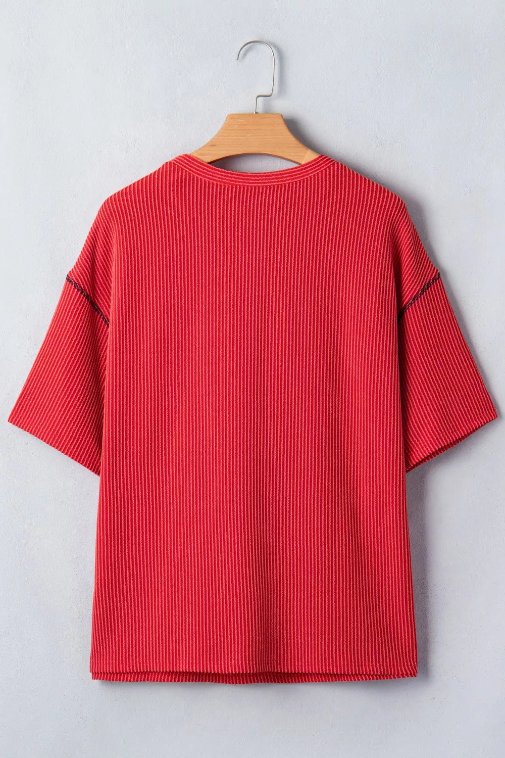 Red ribbed crew neck t-shirt with short sleeves and contrasting stitching detail.