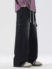 Black oversized cargo jeans with drawstring waist and large side pockets.